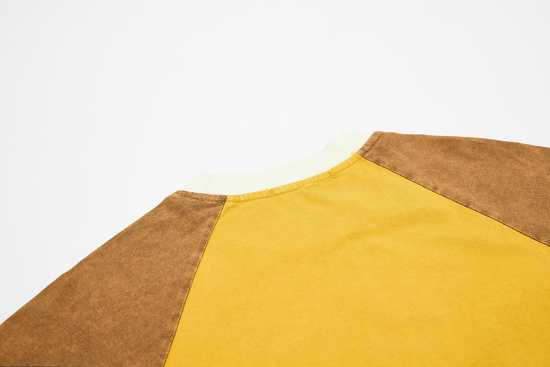 Washed raglan tee in mustard yellow and brown with vintage fade and cream crew neckline