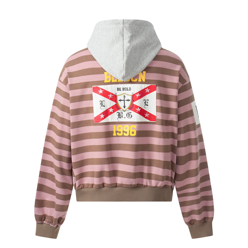 Back view of pink and brown striped hoodie with grey hood, red flag patch, and yellow 1996 text
