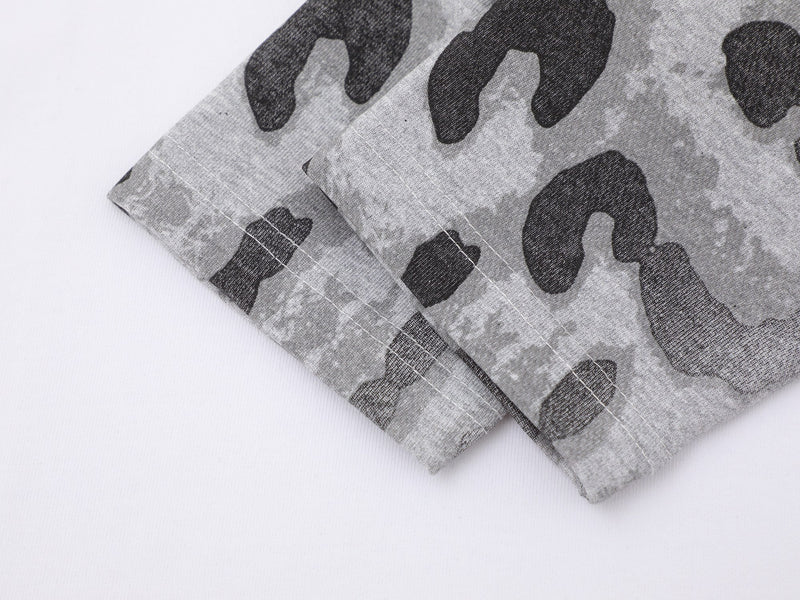 Close-up of gray leopard-print sleeve cuff and stitching on white tee