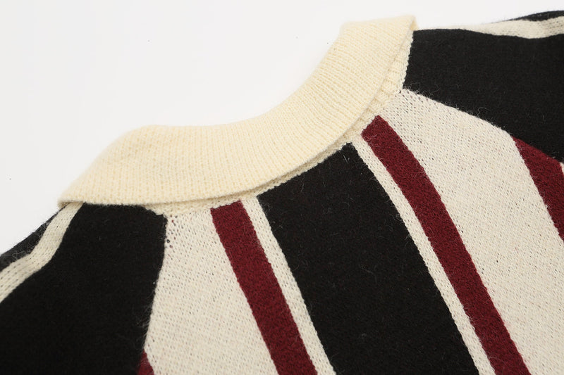 Close-up of cream ribbed crew neck on black, cream, and burgundy striped knit sweater