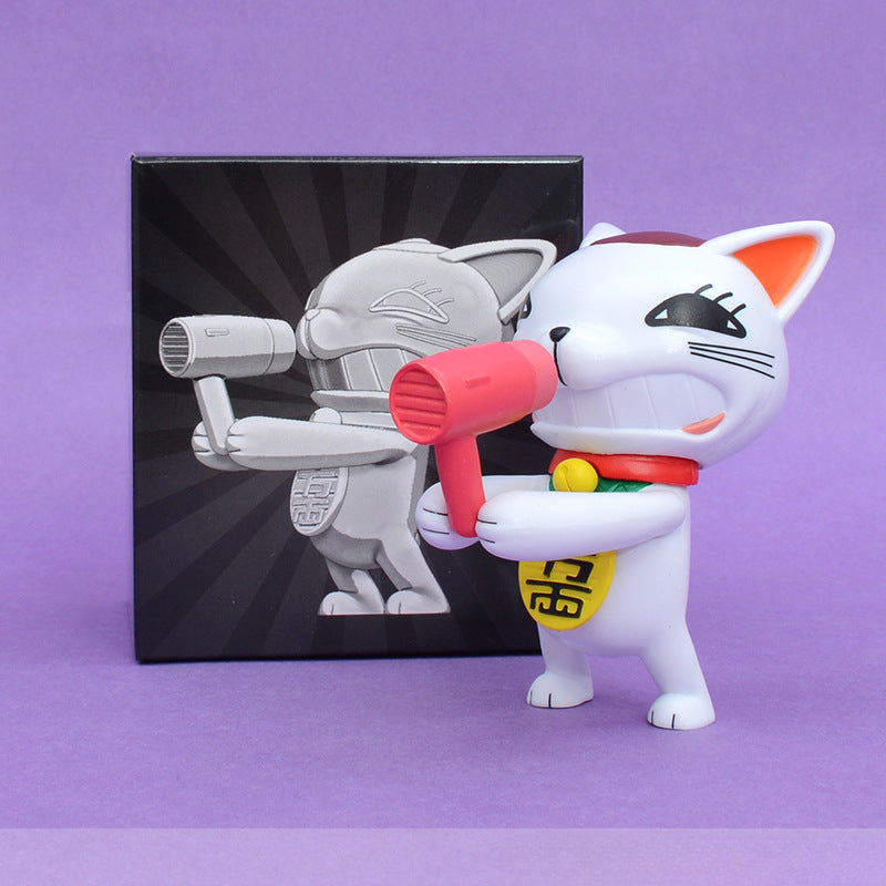 A 9.5 cm Dandadan Lucky Cat PVC figure, featuring a cute anime cat with a hairdryer, stands on a purple surface. It has whiskers and a red collar with a yellow tag. Behind it, the box displays the kawaii-style figure against a starburst backdrop.