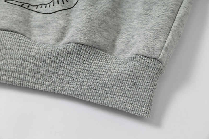 Close-up of ribbed hem on grey graphic hoodie