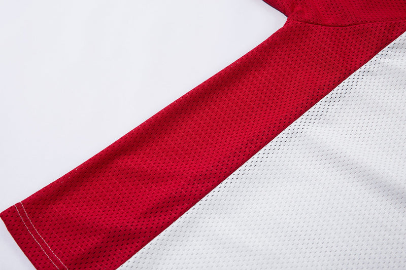 Close-up of a red and white mesh polo jersey with diagonal patchwork panels and visible textured fabric stitching