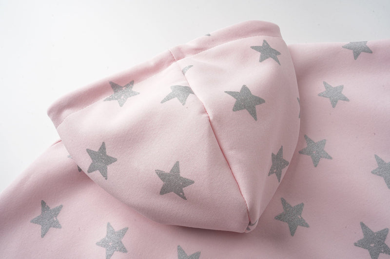 Pink hoodie hood and shoulder close-up with silver stars