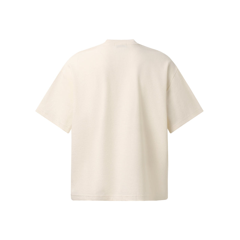 Cream waffle-knit streetwear T-shirt with a relaxed fit and short sleeves, shown from the back on a clean white background