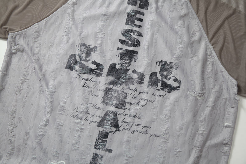 Distressed grey mesh patchwork tee with faded black graphic lettering and textured jersey fabric