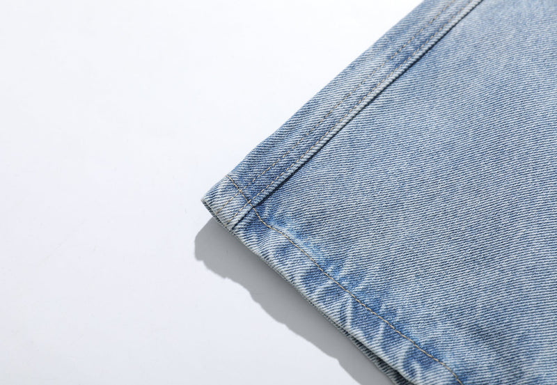 Light wash denim shorts hem close-up with stitched cuff and fading