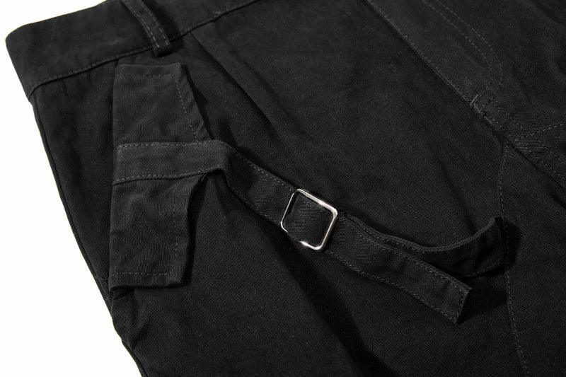 Black shorts side strap and metal buckle detail, close-up
