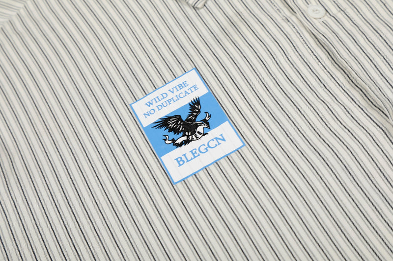 Cream pinstripe button-up shirt with blue graphic patch reading Wild Vibe No Duplicate and BLEGCN