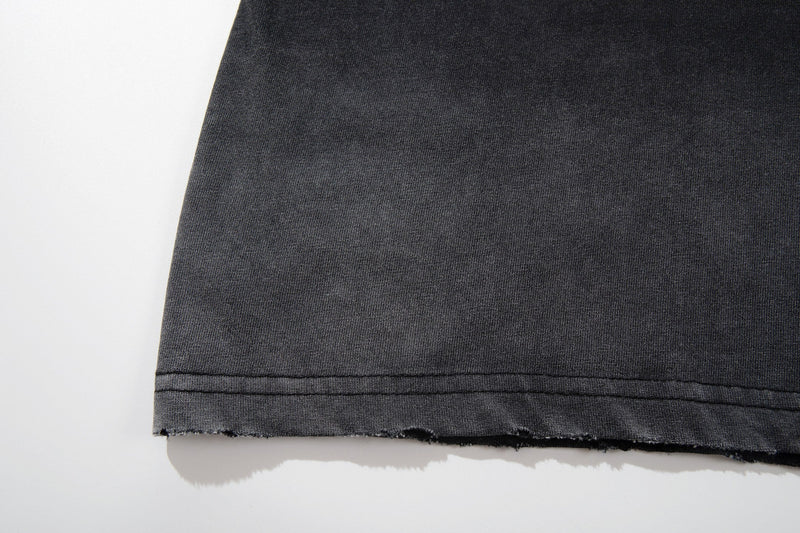 Black washed vintage graphic tee hem with raw distressed edge and stitched seam detail