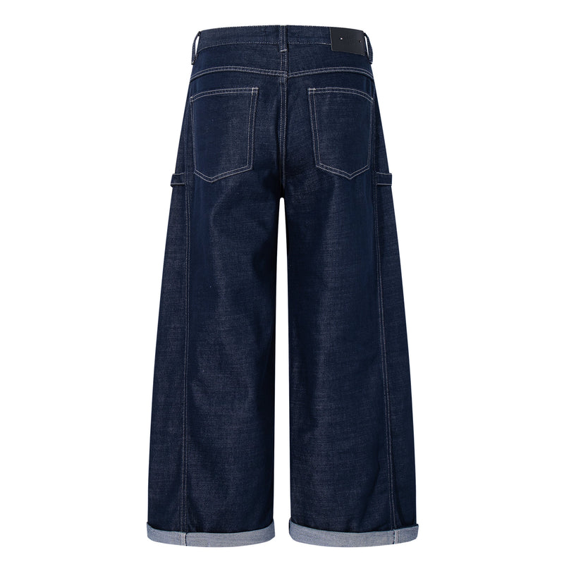 Back view of deep-indigo wide-leg jeans with patch pockets and cuffed hems