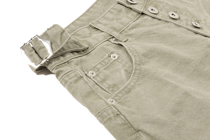 Close-up of olive green denim shorts front pocket and metal buckle