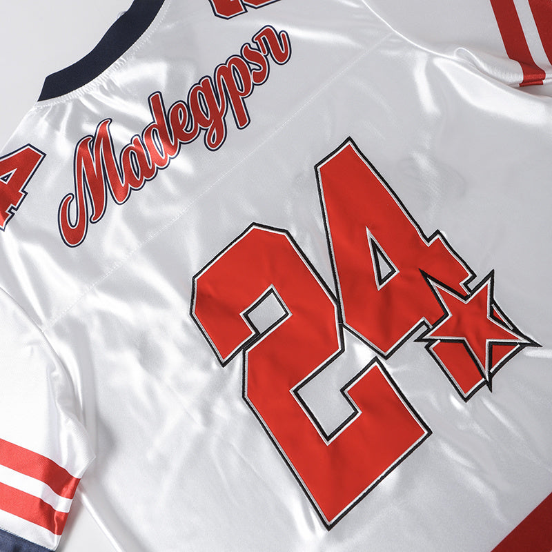 Mad Gypsr 24 white varsity football jersey with red lettering, striped sleeves, and bold retro streetwear graphics