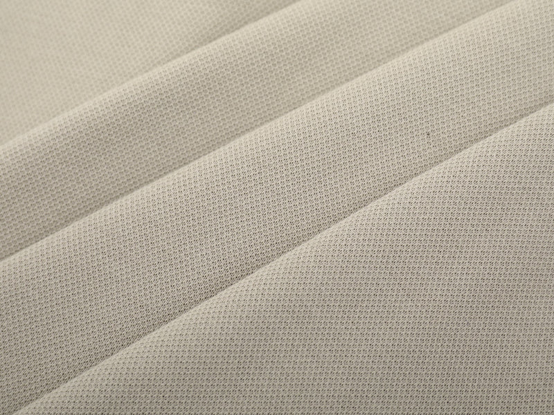 Close-up of beige sweatshirt fabric texture with soft folded drape