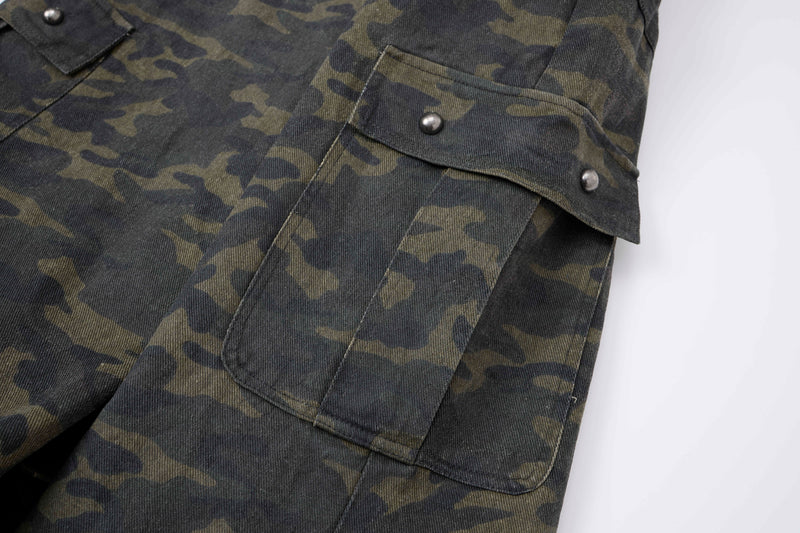 Close-up of camo cargo pants side cargo pocket with flap and silver stud accents