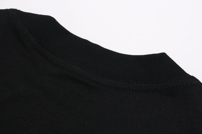Black T-shirt close-up showing ribbed crew neck and stitched collar detail on a gothic streetwear tee
