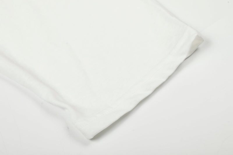 Close-up of white tee sleeve hem and stitched cuff