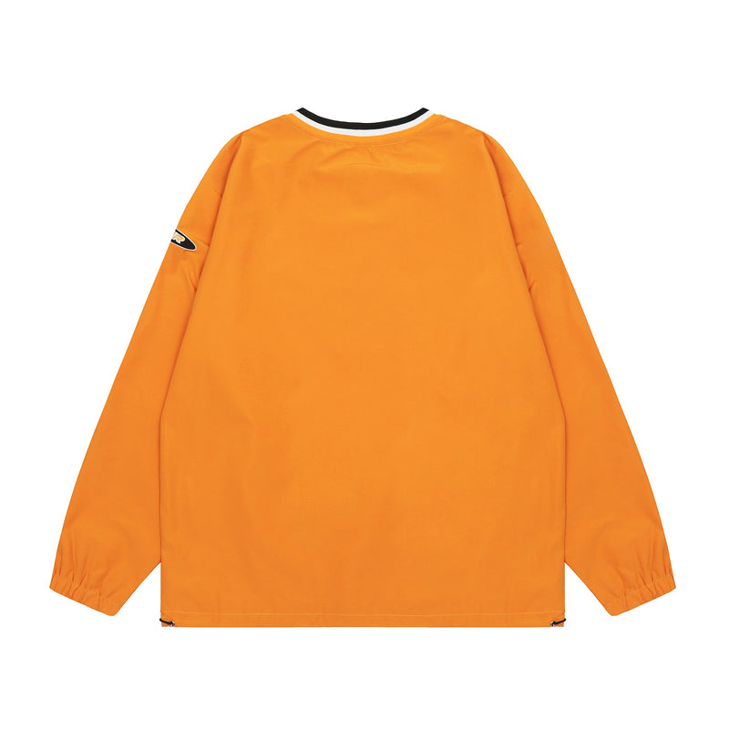 Back view of orange oversized windbreaker with black and white ribbed neck trim