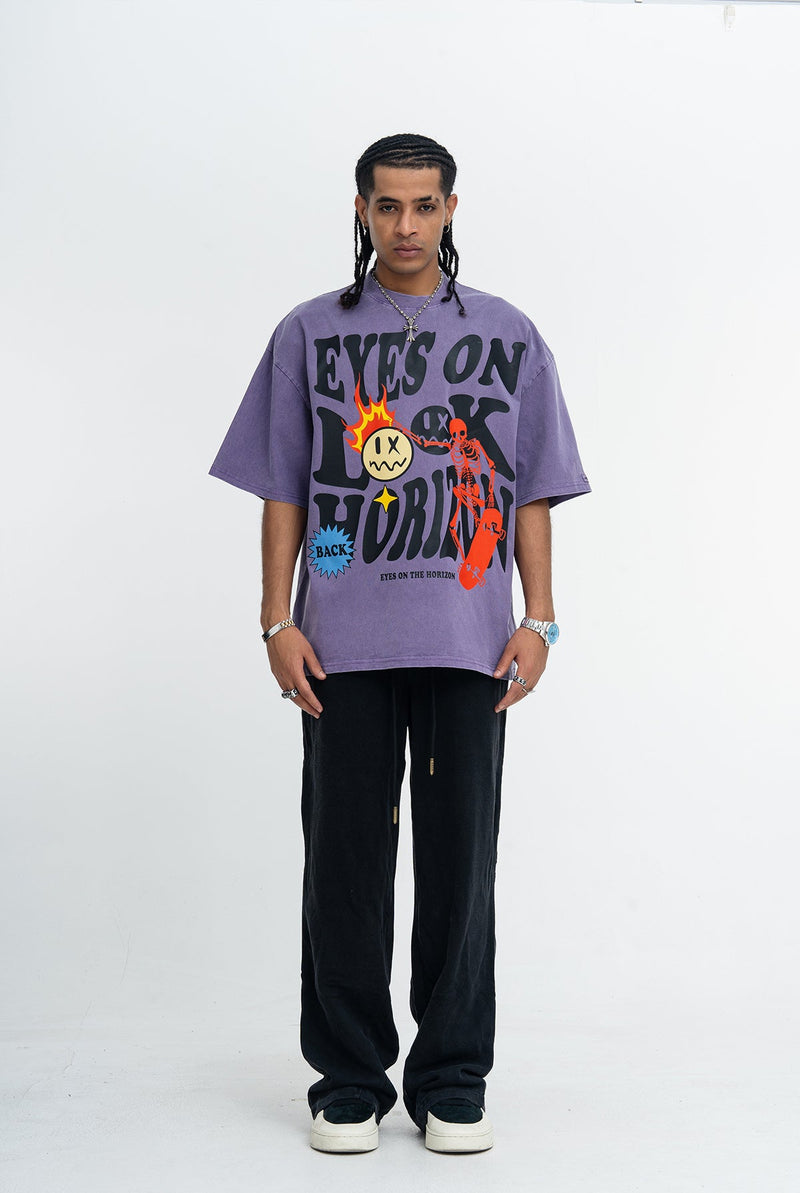 Purple vintage wash graphic tee with bold Eyes on the Horizon skate print, worn with black pants and sneakers