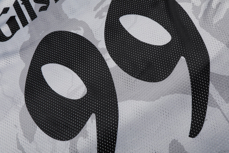 Close-up of a black-and-white mesh football jersey with bold portrait graphic and large number 99 print