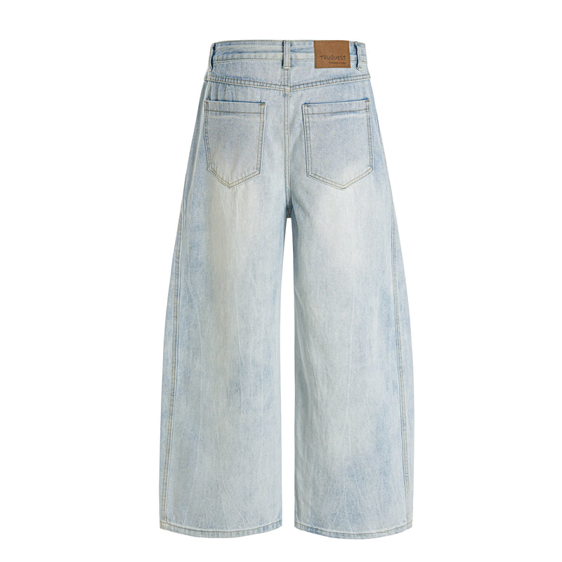 Light wash wide-leg jeans back view with two patch pockets and tan logo patch at waistband