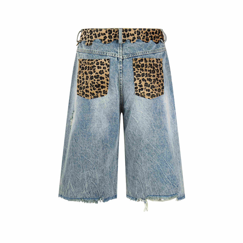 Back view of distressed denim shorts with leopard print patch pockets and scalloped waistband