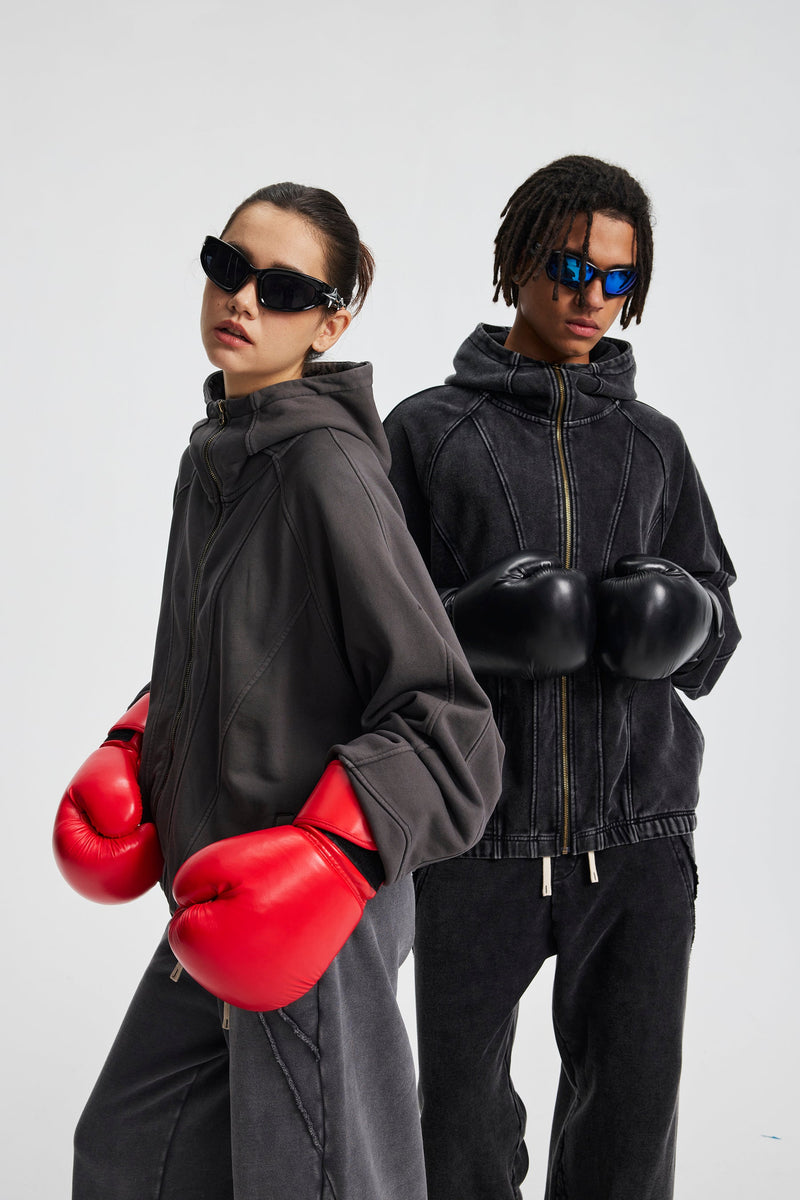 Two models in curved-seam hoodies wearing boxing gloves, side-by-side view