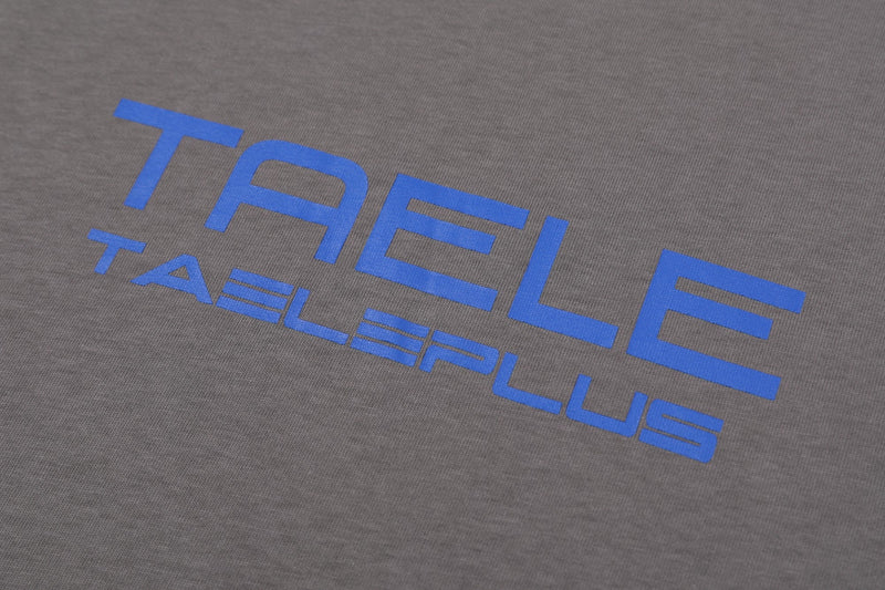 Gray streetwear T-shirt with bold blue TAELEPLUS logo print across the chest