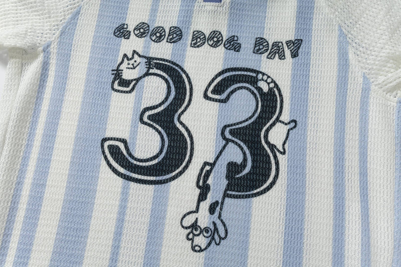 Blue and white striped knit polo tee with a bold 31 Good Dog graphic and playful cartoon dog print