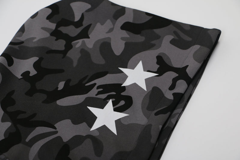 Close-up of black and gray camo fabric with white star print