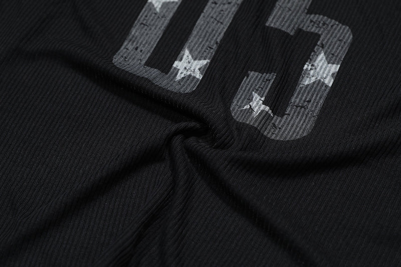 Close-up of black fabric print with large 05 numbers and star details