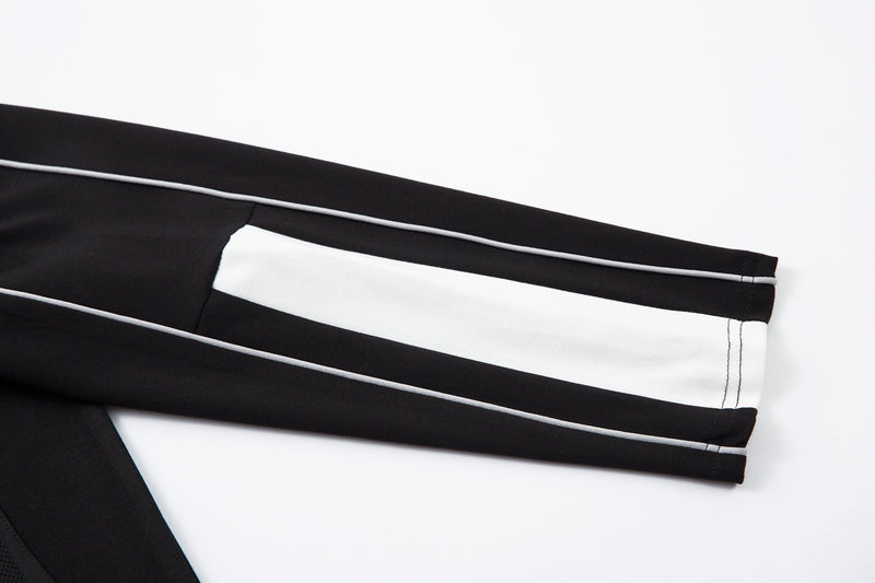 White sleeve close-up with black stripe and contrast stitching