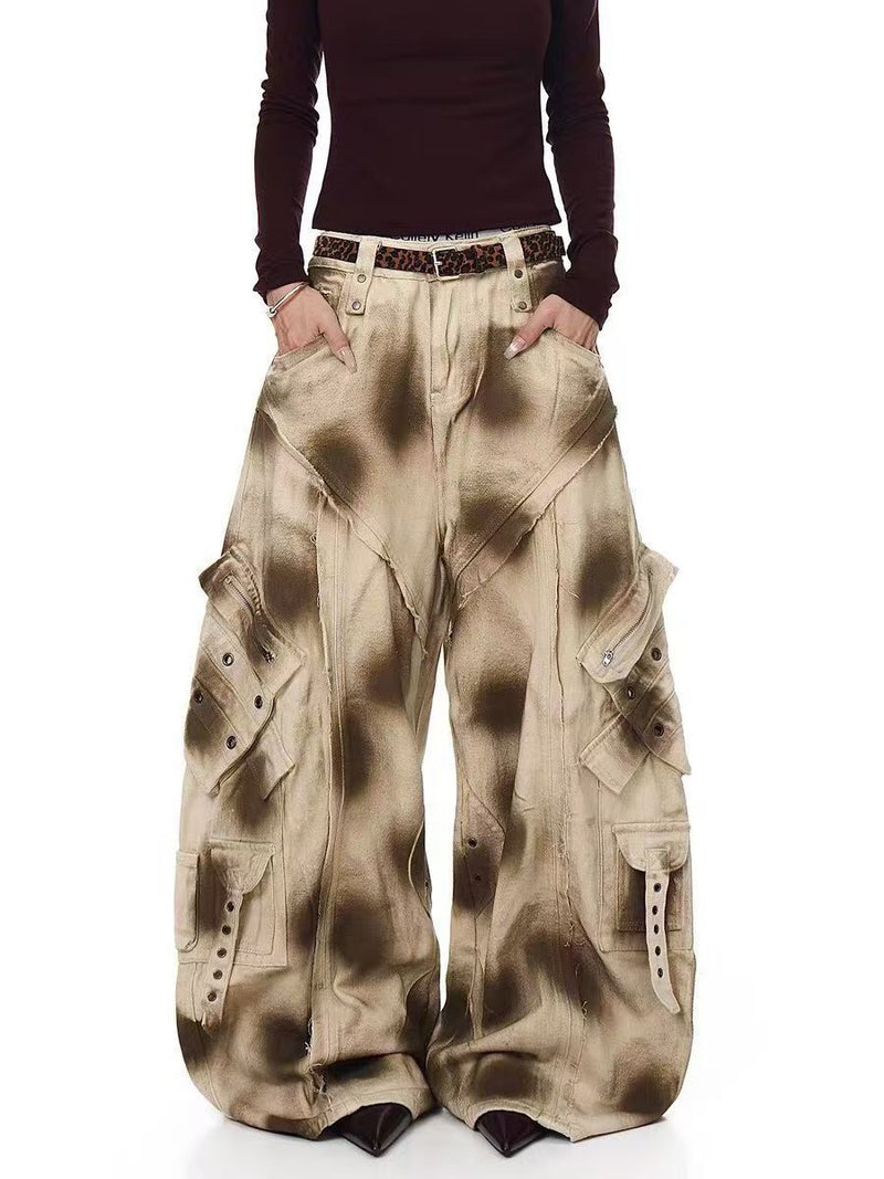 Model wearing distressed beige cargo barrel pants with oversized legs and a leopard print belt