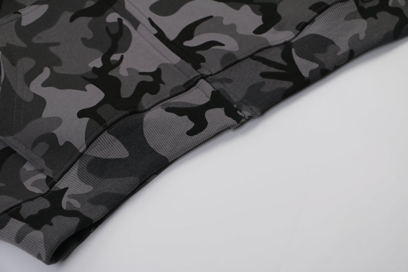 Close-up of camo hoodie hem and ribbed waistband stitching