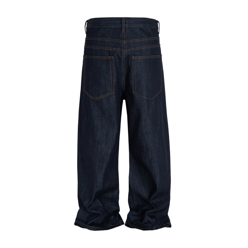 Back view of dark indigo straight-leg jeans with patch pockets and stacked hems