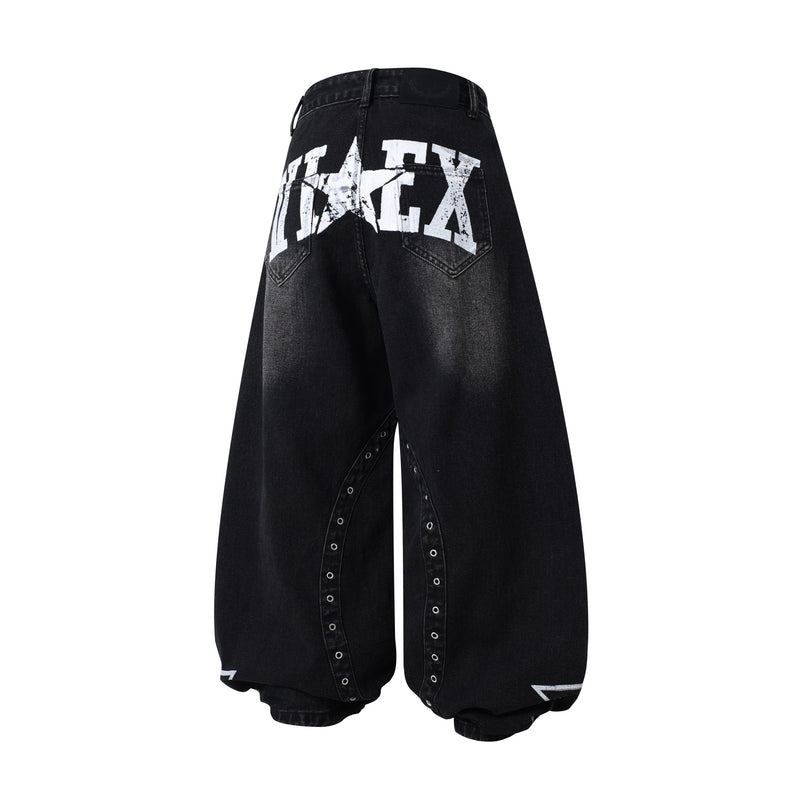 Black wide-leg jeans back view with large distressed white lettering across the yoke