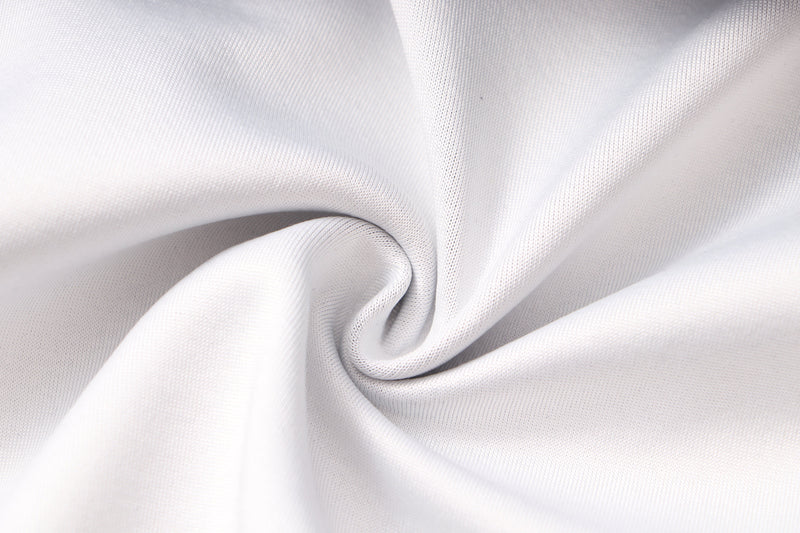 White fabric close-up showing smooth knit texture and soft folds