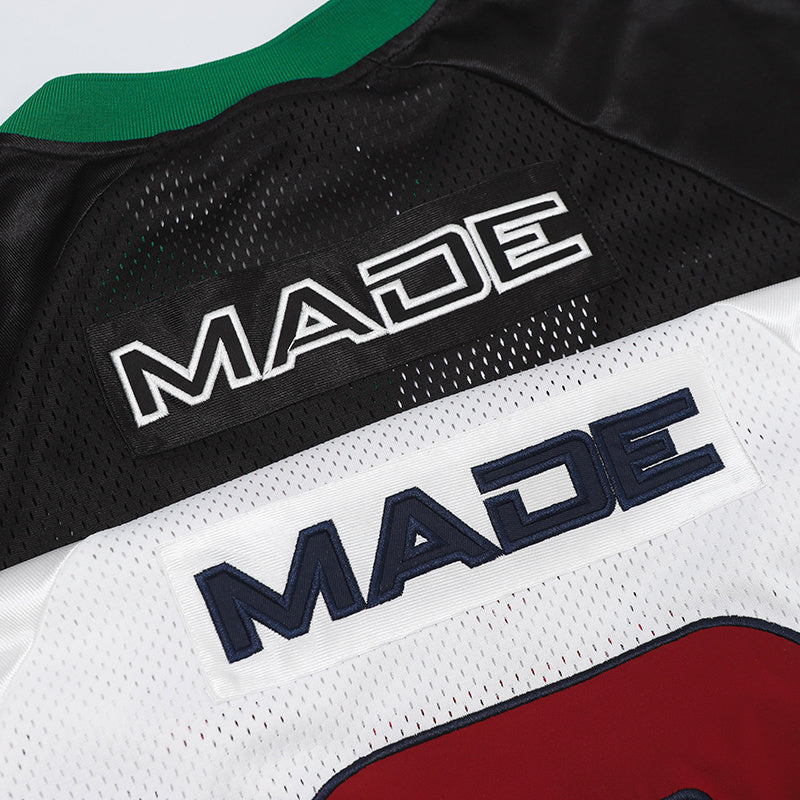 Close-up of Seakoff performance jersey with black, white, and red number panels and embroidered MADE lettering
