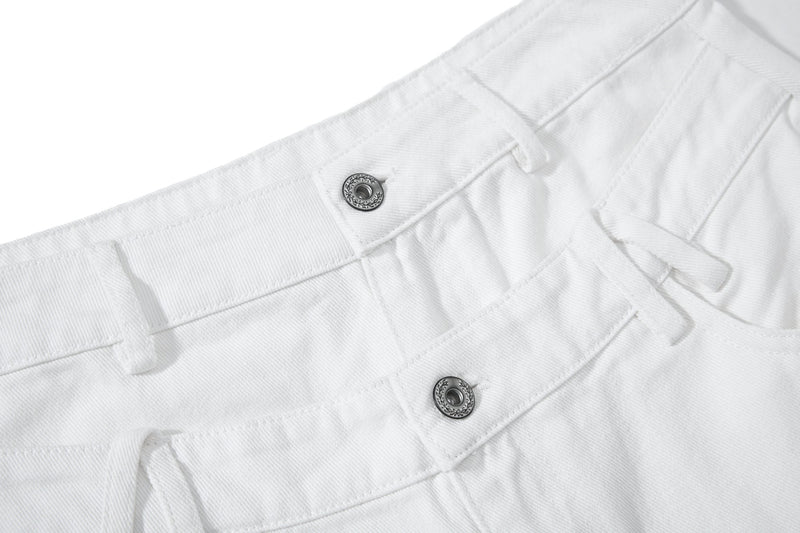 Close-up of white front waistband with two button closures and gathered seams