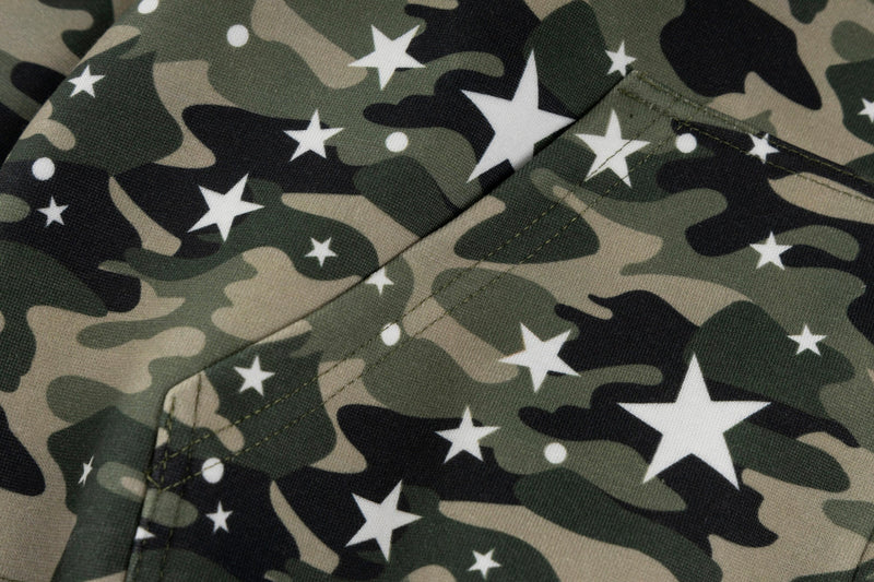 Close-up of camo fabric with white star print and front pocket seam