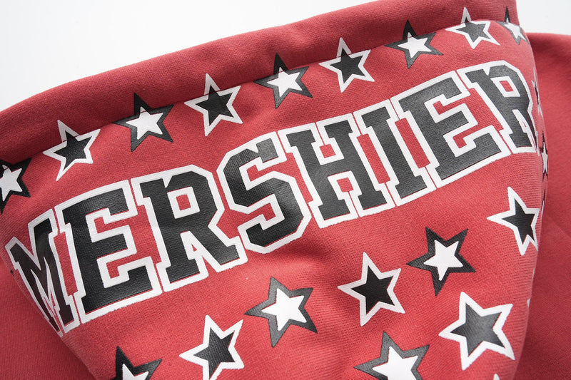Close-up of red hood with star print and MERSHIER lettering on the brim