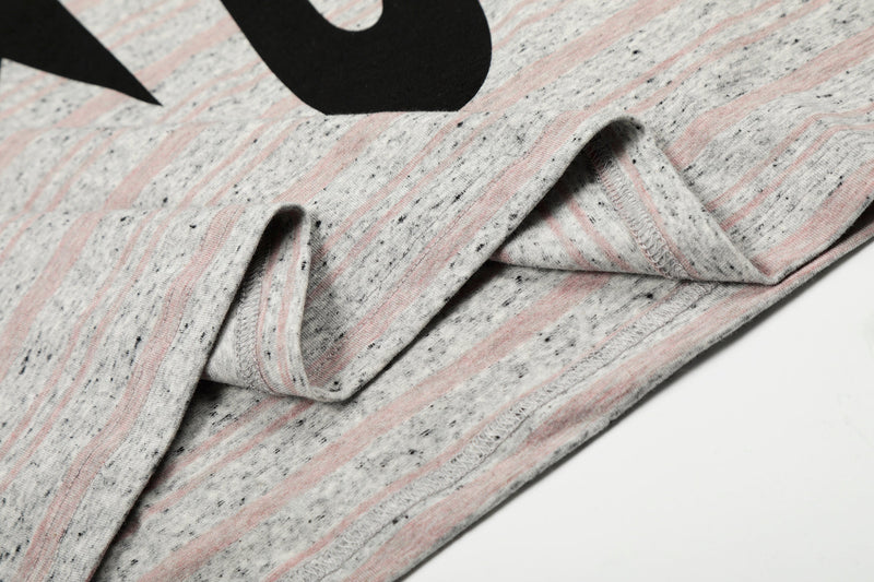 Close-up of sleeve and stitched cuff on gray striped long sleeve tee
