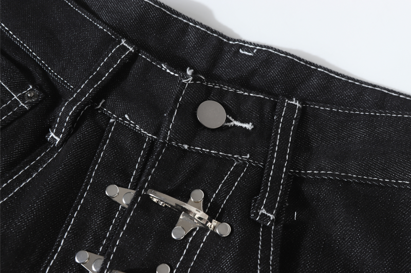 Front waist close-up showing black denim, metal buckle closure, and button waistband detail
