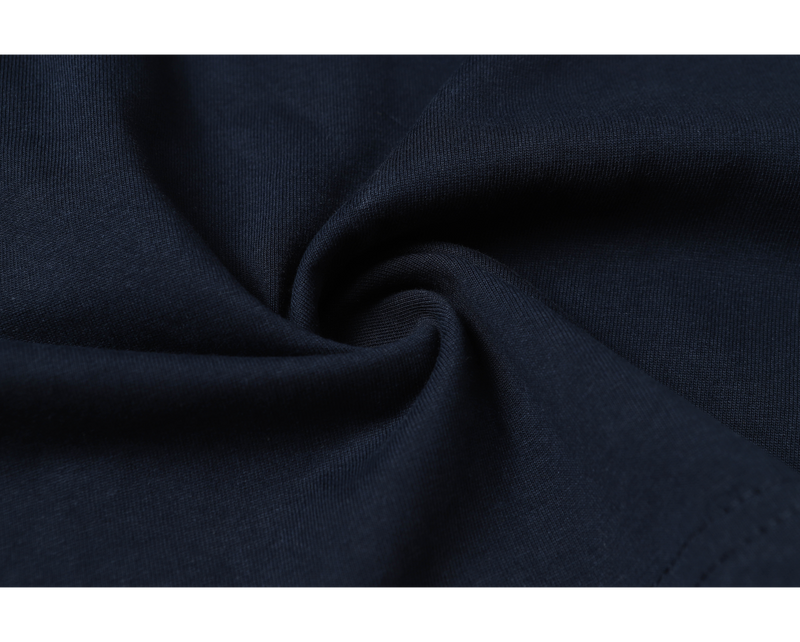Close-up of dark navy knit fabric with soft folds, showing the textured material of the Seakoff graphic T-shirt