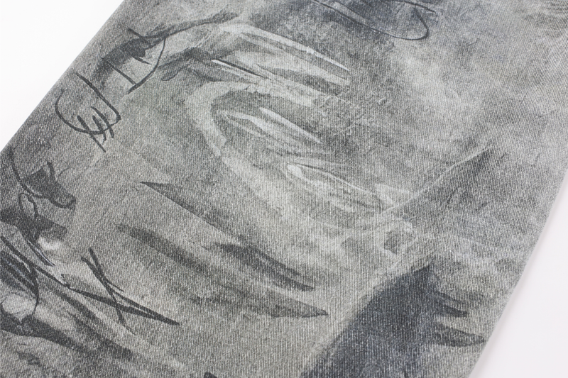 Close-up of faded black and white wash pattern on gray denim fabric