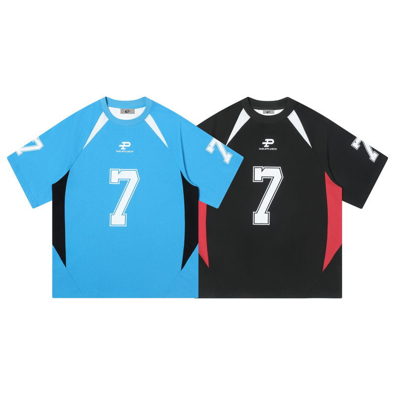Colorblock varsity jersey tee with large number 7 graphic, shown in blue-and-black and black-and-red versions on a white background