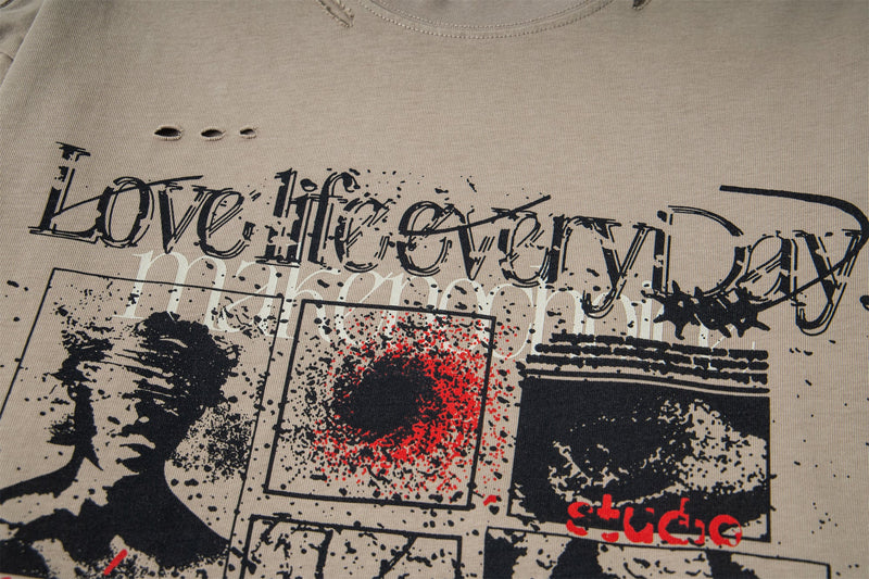 Close-up of front graphic reading Love Life Every Day on beige distressed tee