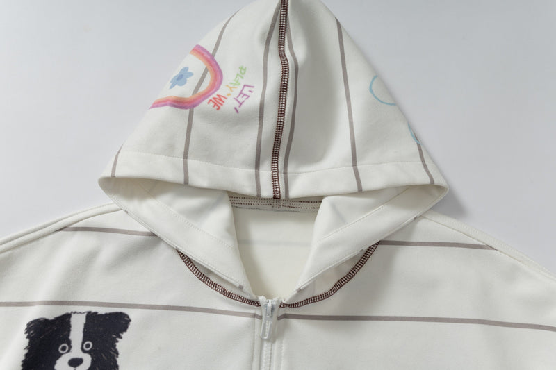 Close-up of hood top on cream zip-up hoodie with rainbow and hand-drawn text print