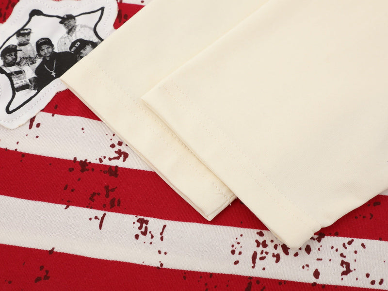 Close-up of cream tee sleeve over striped body with star patch detail