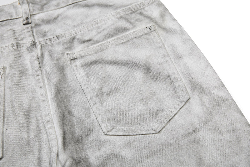 Close-up of light gray cargo pocket with silver rivets